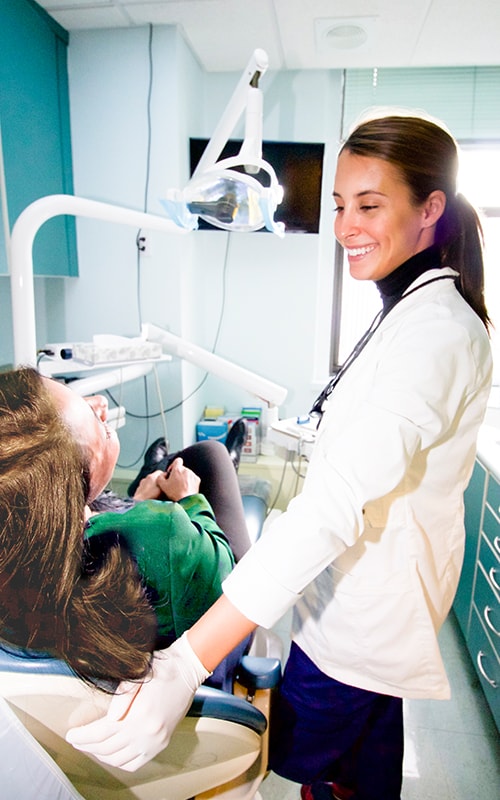 Image of a Midtown NYC Invisalign dentist talking with a young patient